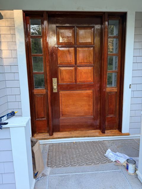 Refinished wood front door with white trim