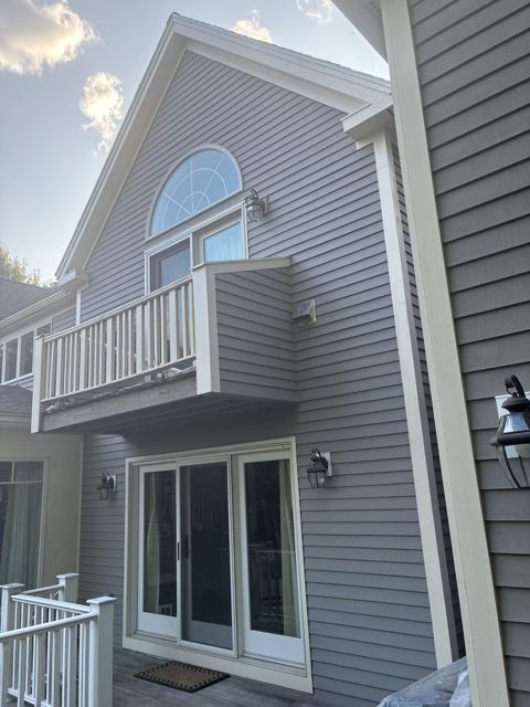 Gray clapboard siding with white trim and French doors