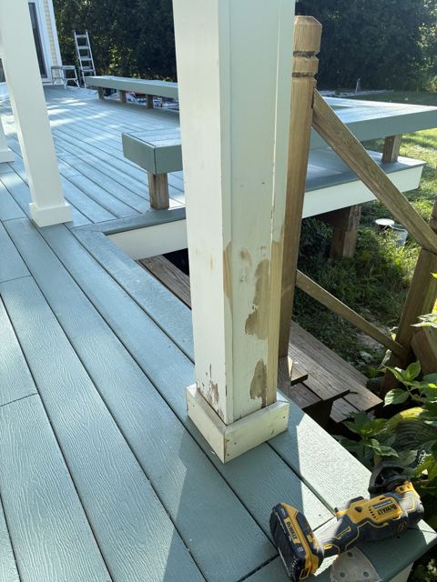 Porch deck painted blue-gray with white posts