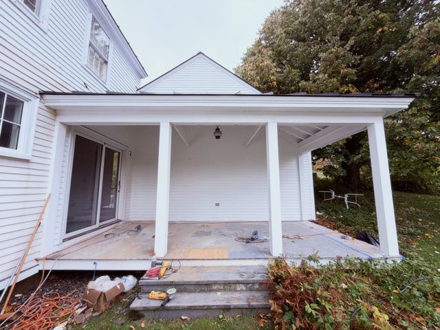 White porch with floor being prepared for a new finish