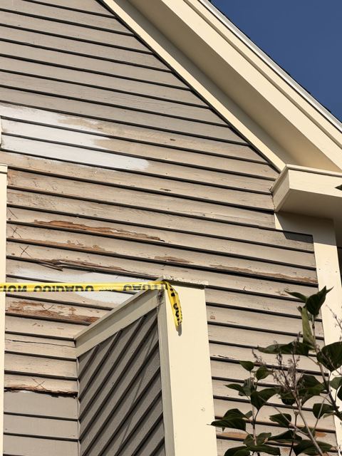 Gray siding prepared for wood repair