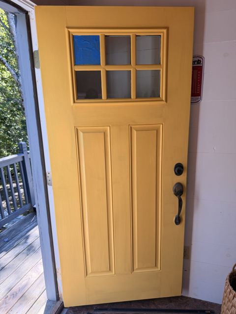 Painted yellow entry door with glass panes